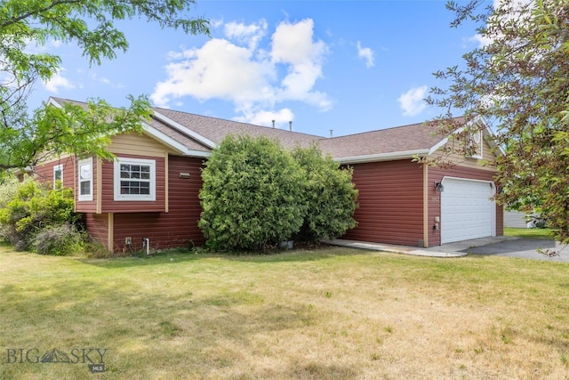 1002 E Northern Pacific Ave, Belgrade, MT 59714 - view of front of home with an attached garage, asphalt driveway, a front lawn, and roof with shingles