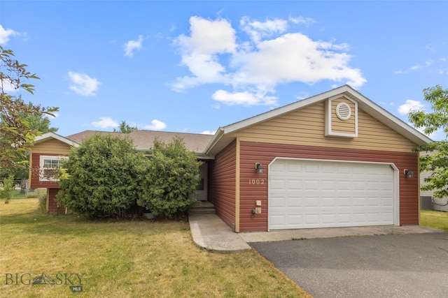 1002 E Northern Pacific Ave, Belgrade, MT 59714 - view of front facade with asphalt driveway, a front lawn, a shingled roof, and a garage