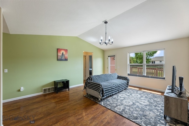 1002 E Northern Pacific Ave, Belgrade, MT 59714 - living room featuring lofted ceiling, a chandelier, and wood finished floors