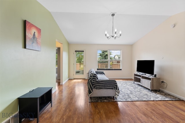 1002 E Northern Pacific Ave, Belgrade, MT 59714 - living area with lofted ceiling, wood finished floors, and a chandelier