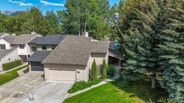 8A Gallatin Dr, Bozeman, MT 59718 - view of front facade with roof with shingles, a garage, driveway, a chimney, and a front lawn