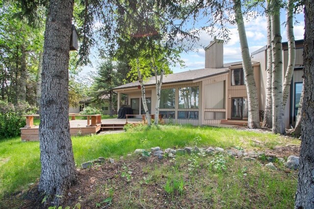8A Gallatin Dr, Bozeman, MT 59718 - back of house featuring a lawn, a chimney, and a deck