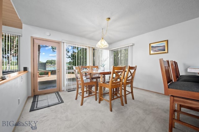 8A Gallatin Dr, Bozeman, MT 59718 - dining space with light carpet, a textured ceiling, and a chandelier
