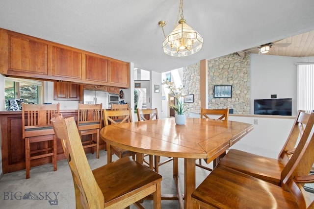 8A Gallatin Dr, Bozeman, MT 59718 - dining area with a chandelier, light colored carpet, and a ceiling fan