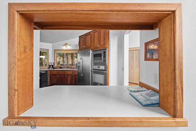 8A Gallatin Dr, Bozeman, MT 59718 - kitchen featuring stainless steel appliances, light countertops, and brown cabinets