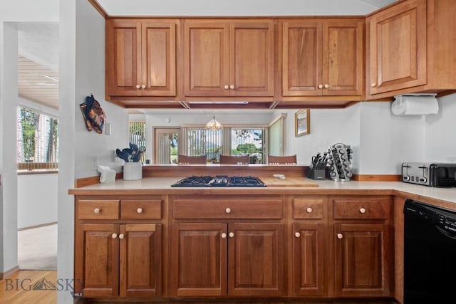 8A Gallatin Dr, Bozeman, MT 59718 - kitchen with dishwasher, gas cooktop, light countertops, and brown cabinetry