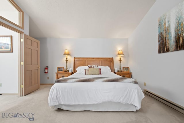 8A Gallatin Dr, Bozeman, MT 59718 - bedroom featuring a baseboard heating unit, light carpet, and vaulted ceiling