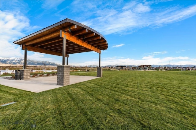 608 Mira Way Unit A, Belgrade, MT 59714 - view of green lawn with a mountain view and a patio