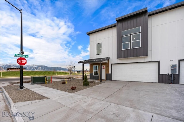 608 Mira Way Unit A, Belgrade, MT 59714 - contemporary home with a mountain view, a garage, driveway, board and batten siding, and a metal roof