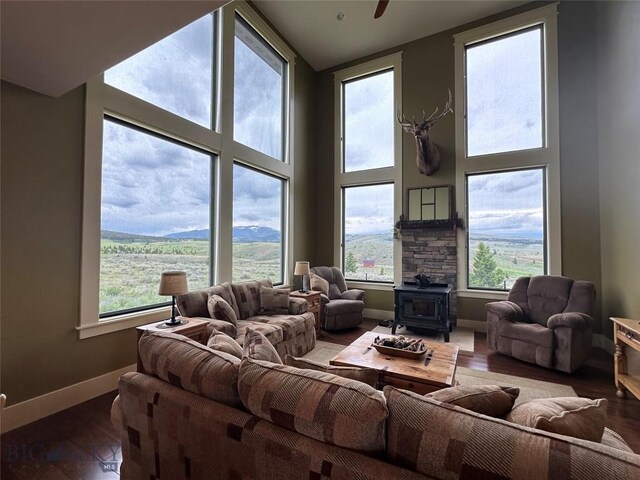 64 Mountain View Trl, White Sulphur Springs, MT 59645 - living area with a wood stove, plenty of natural light, wood finished floors, and a towering ceiling