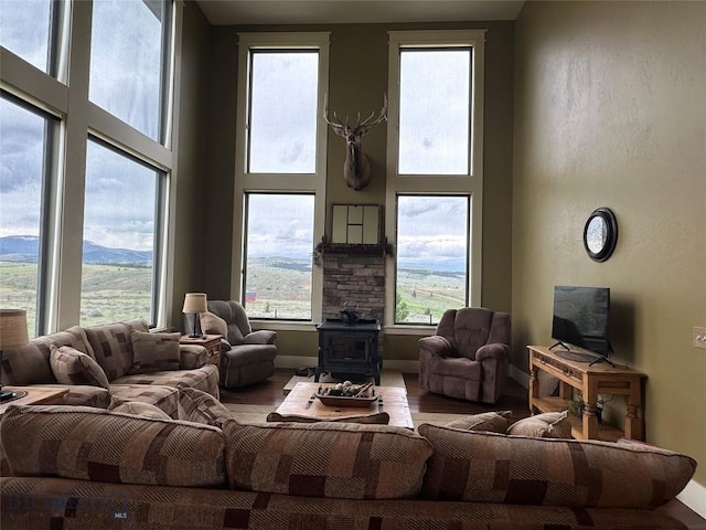 64 Mountain View Trl, White Sulphur Springs, MT 59645 - living area with a wood stove, a towering ceiling, and wood finished floors