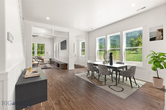 189 Blue Creek Rd, Heron, MT 59844 - dining room with wood finished floors, a decorative wall, recessed lighting, and wainscoting
