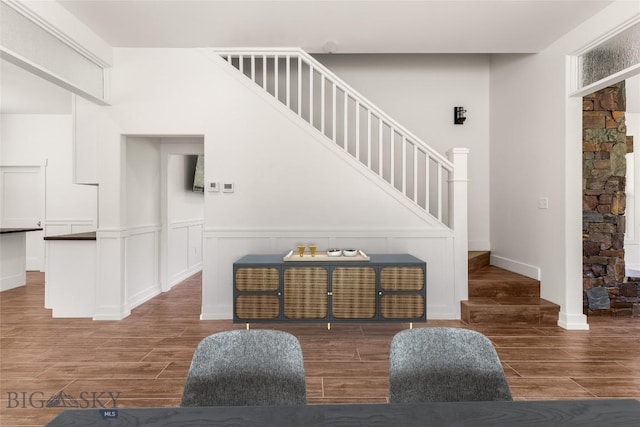 189 Blue Creek Rd, Heron, MT 59844 - stairway featuring wood finished floors and a wainscoted wall