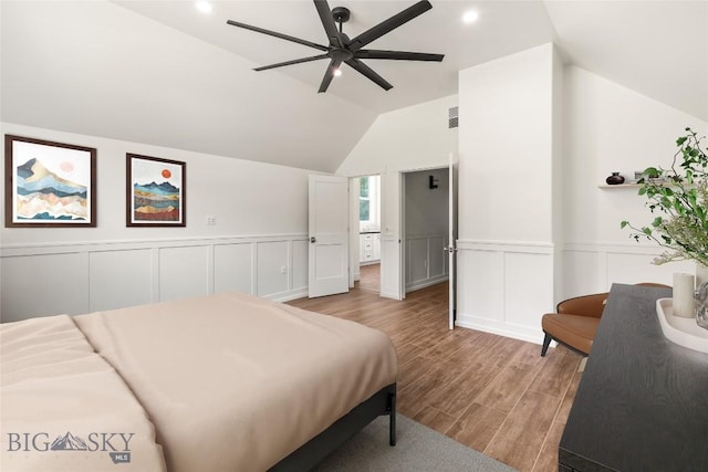 189 Blue Creek Rd, Heron, MT 59844 - bedroom with light wood-style floors, lofted ceiling, wainscoting, a decorative wall, and ceiling fan
