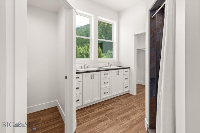 189 Blue Creek Rd, Heron, MT 59844 - full bathroom with wood finished floors, double vanity, and a shower with shower curtain