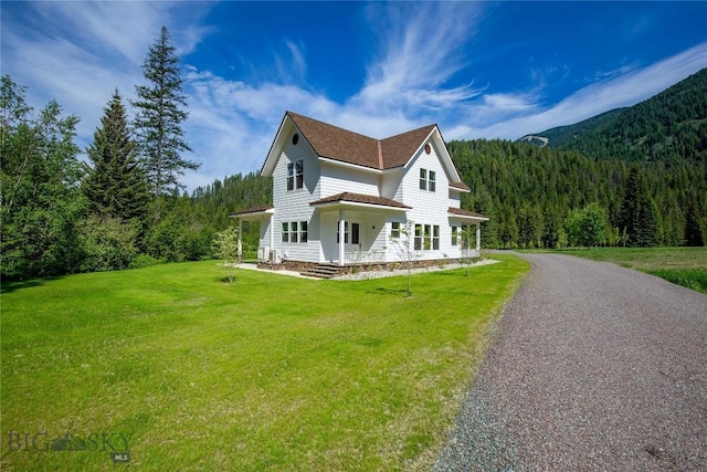 189 Blue Creek Rd, Heron, MT 59844 - view of front of property with a view of trees, covered porch, and a front lawn