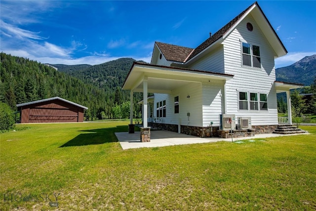 189 Blue Creek Rd, Heron, MT 59844 - rear view of house with a mountain view, a yard, and a view of trees