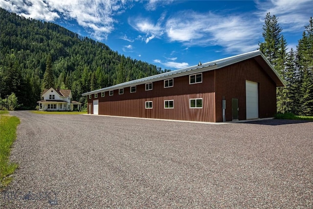 189 Blue Creek Rd, Heron, MT 59844 - view of property exterior with a forest view, a garage, and a mountain view