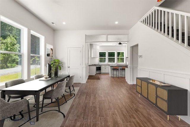 189 Blue Creek Rd, Heron, MT 59844 - dining space with dark wood-style flooring, ceiling fan, wainscoting, and recessed lighting