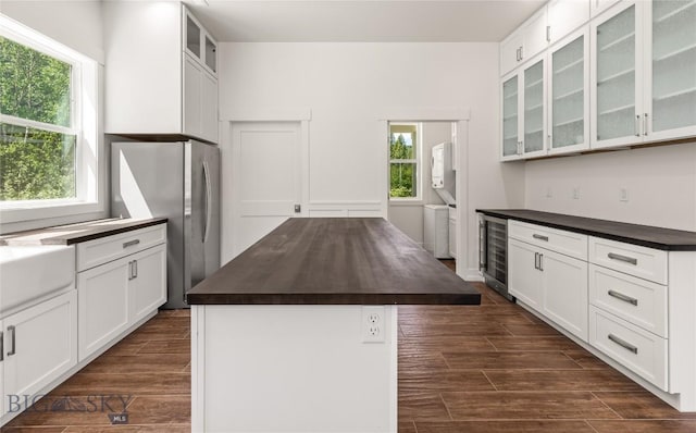 189 Blue Creek Rd, Heron, MT 59844 - kitchen featuring beverage cooler, freestanding refrigerator, a center island, and white cabinets