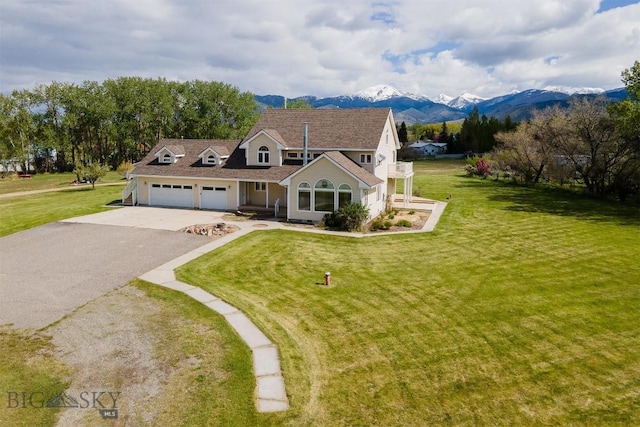 507 E Poppleton, Sheridan, MT 59749 - view of front facade with driveway, an attached garage, a mountain view, and a front yard