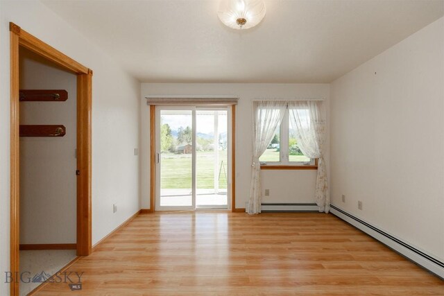 507 E Poppleton, Sheridan, MT 59749 - spare room with a baseboard heating unit, light wood-style floors, and a baseboard radiator