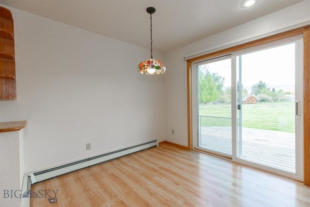 507 E Poppleton, Sheridan, MT 59749 - unfurnished dining area with a baseboard radiator, light wood-style flooring, and recessed lighting