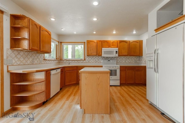 507 E Poppleton, Sheridan, MT 59749 - kitchen with white appliances, open shelves, a center island, light countertops, and light wood finished floors