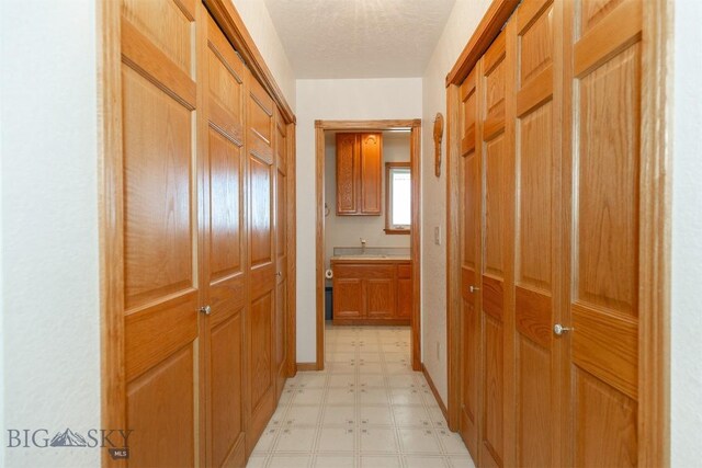507 E Poppleton, Sheridan, MT 59749 - hall featuring light flooring and a textured ceiling