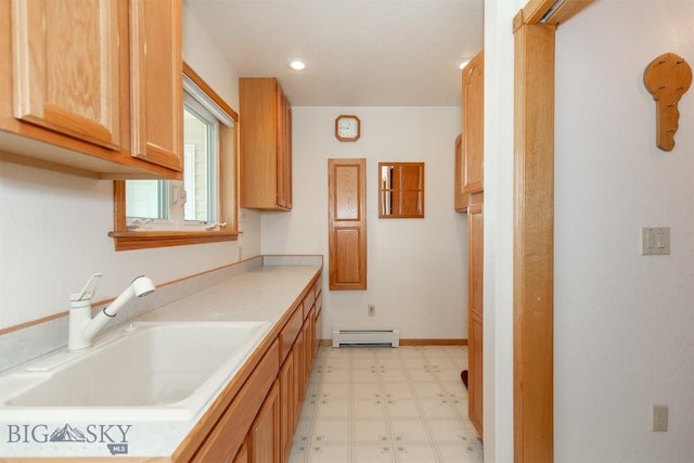 507 E Poppleton, Sheridan, MT 59749 - kitchen featuring baseboard heating, light floors, and light countertops