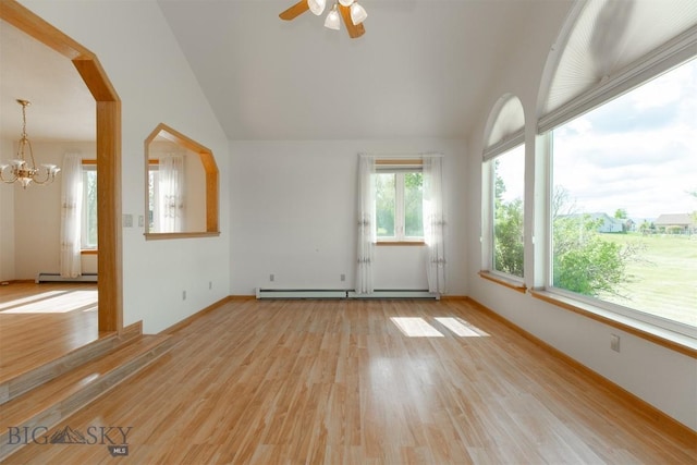 507 E Poppleton, Sheridan, MT 59749 - empty room featuring light wood-style floors, a chandelier, a baseboard radiator, vaulted ceiling, and ceiling fan