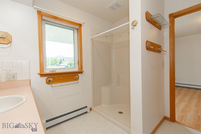 507 E Poppleton, Sheridan, MT 59749 - bathroom featuring a baseboard radiator, a shower, and vanity