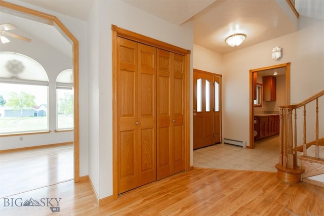507 E Poppleton, Sheridan, MT 59749 - entrance foyer featuring a baseboard radiator, stairs, light wood-style flooring, and ceiling fan