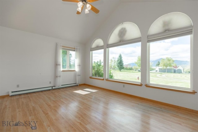 507 E Poppleton, Sheridan, MT 59749 - empty room featuring a baseboard heating unit, light wood-style flooring, a ceiling fan, and vaulted ceiling