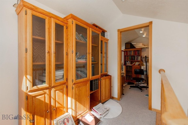 507 E Poppleton, Sheridan, MT 59749 - hall featuring vaulted ceiling, light carpet, and an office area