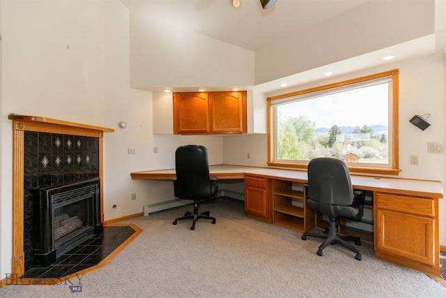 507 E Poppleton, Sheridan, MT 59749 - office space with light carpet, a tile fireplace, baseboard heating, high vaulted ceiling, and built in desk