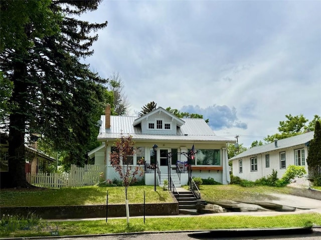 108 S 8th St, Livingston, MT 59047 - bungalow-style home featuring a porch, a metal roof, and a chimney