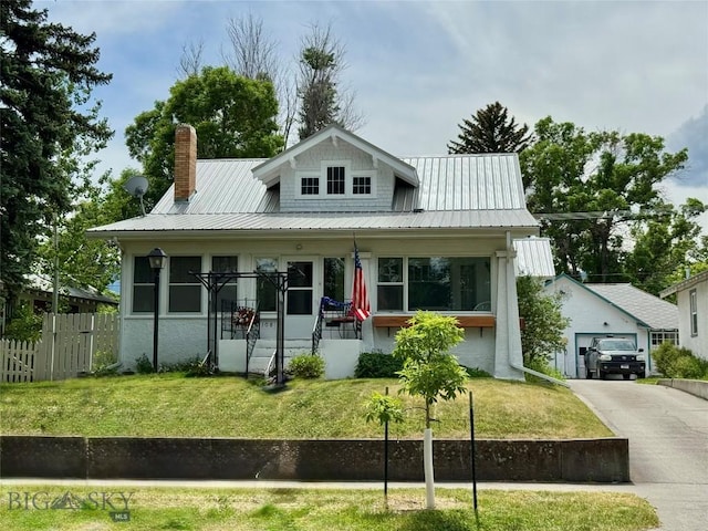 108 S 8th St, Livingston, MT 59047 - view of front of house with a chimney, an outbuilding, a metal roof, and asphalt driveway