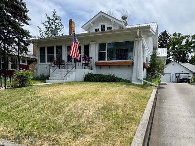108 S 8th St, Livingston, MT 59047 - bungalow featuring a front lawn, a chimney, a metal roof, and an outdoor structure
