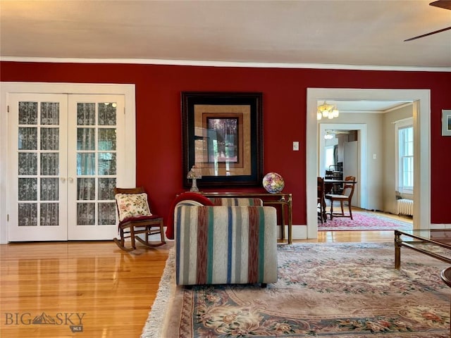 108 S 8th St, Livingston, MT 59047 - living room featuring ornamental molding, wood finished floors, radiator, ceiling fan, and french doors