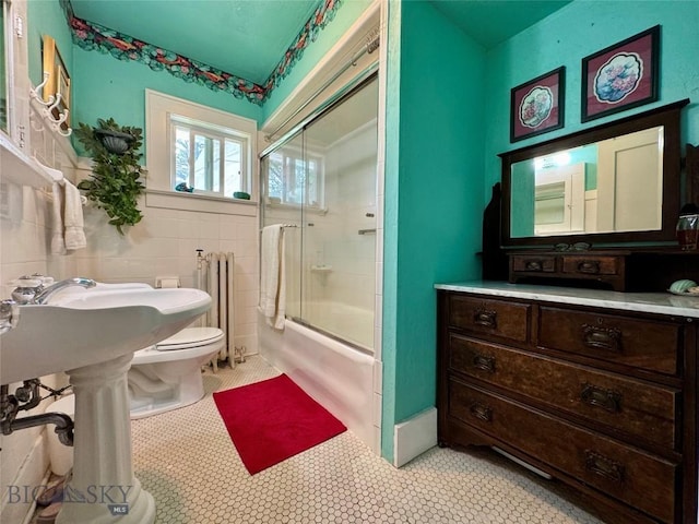 108 S 8th St, Livingston, MT 59047 - full bath featuring combined bath / shower with glass door, radiator, and tile patterned floors