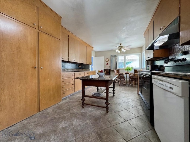 108 S 8th St, Livingston, MT 59047 - kitchen featuring dishwasher, under cabinet range hood, ceiling fan, dark countertops, and range