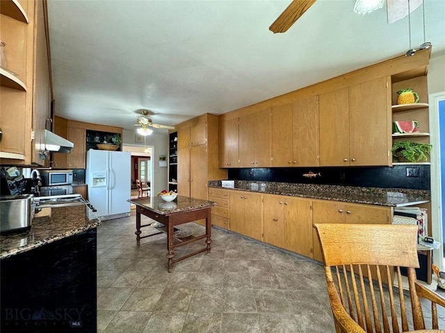 108 S 8th St, Livingston, MT 59047 - kitchen with ceiling fan, white refrigerator with ice dispenser, open shelves, stainless steel microwave, and under cabinet range hood