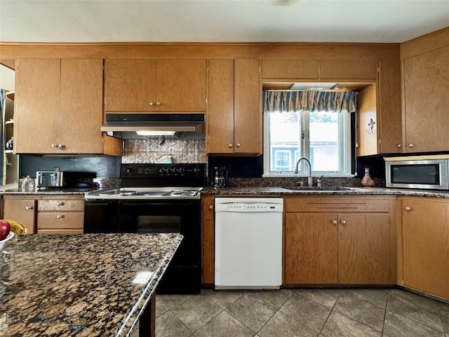 108 S 8th St, Livingston, MT 59047 - kitchen with white dishwasher, stainless steel microwave, range with electric stovetop, under cabinet range hood, and decorative backsplash