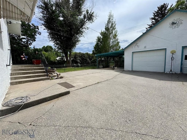 108 S 8th St, Livingston, MT 59047 - view of side of home featuring concrete driveway and stucco siding