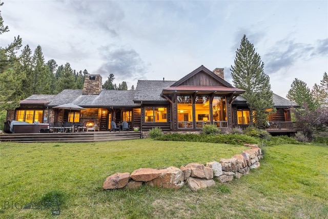 2055 Ousel Falls Rd, Big Sky, MT 59716 - rear view of property featuring a chimney and a yard