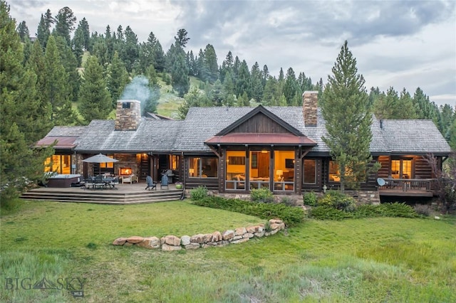 2055 Ousel Falls Rd, Big Sky, MT 59716 - rear view of house with a chimney and a yard
