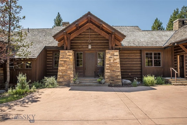 2055 Ousel Falls Rd, Big Sky, MT 59716 - property entrance with a chimney and board and batten siding