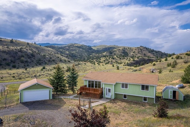 3 Evening Star Dr, Emigrant, MT 59027 - view of front of property with a storage shed, a garage, and a deck with mountain view