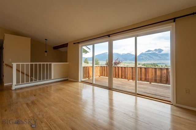 3 Evening Star Dr, Emigrant, MT 59027 - spare room with a baseboard heating unit, a mountain view, wood finished floors, and lofted ceiling